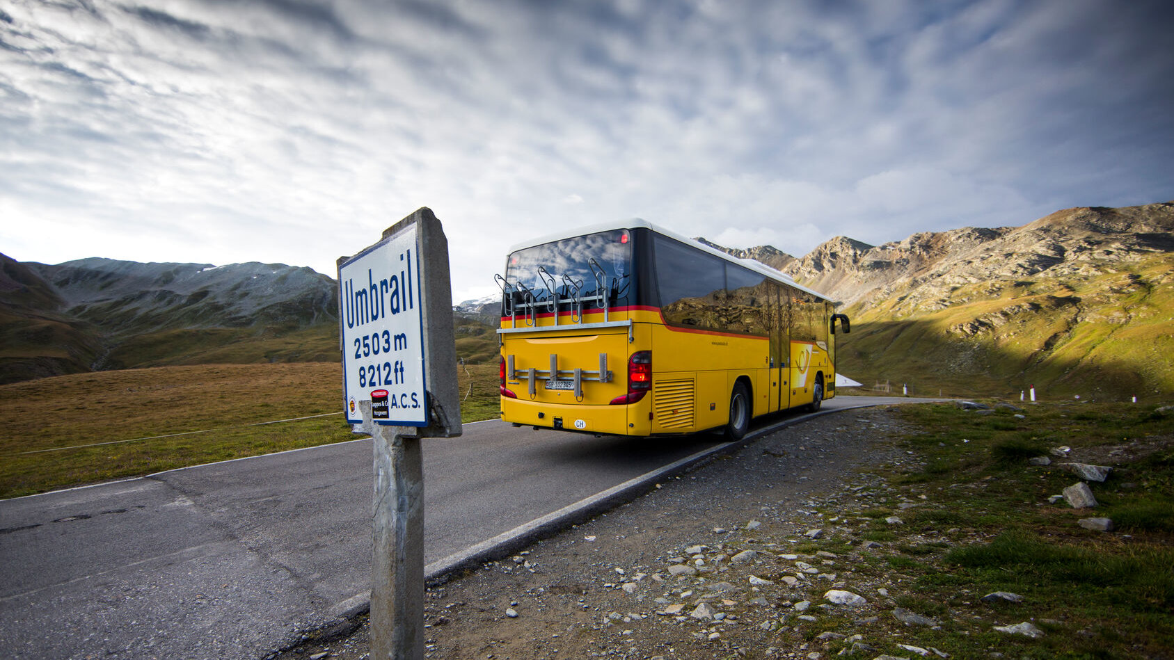PostAuto PostAuto bus on a mountain street